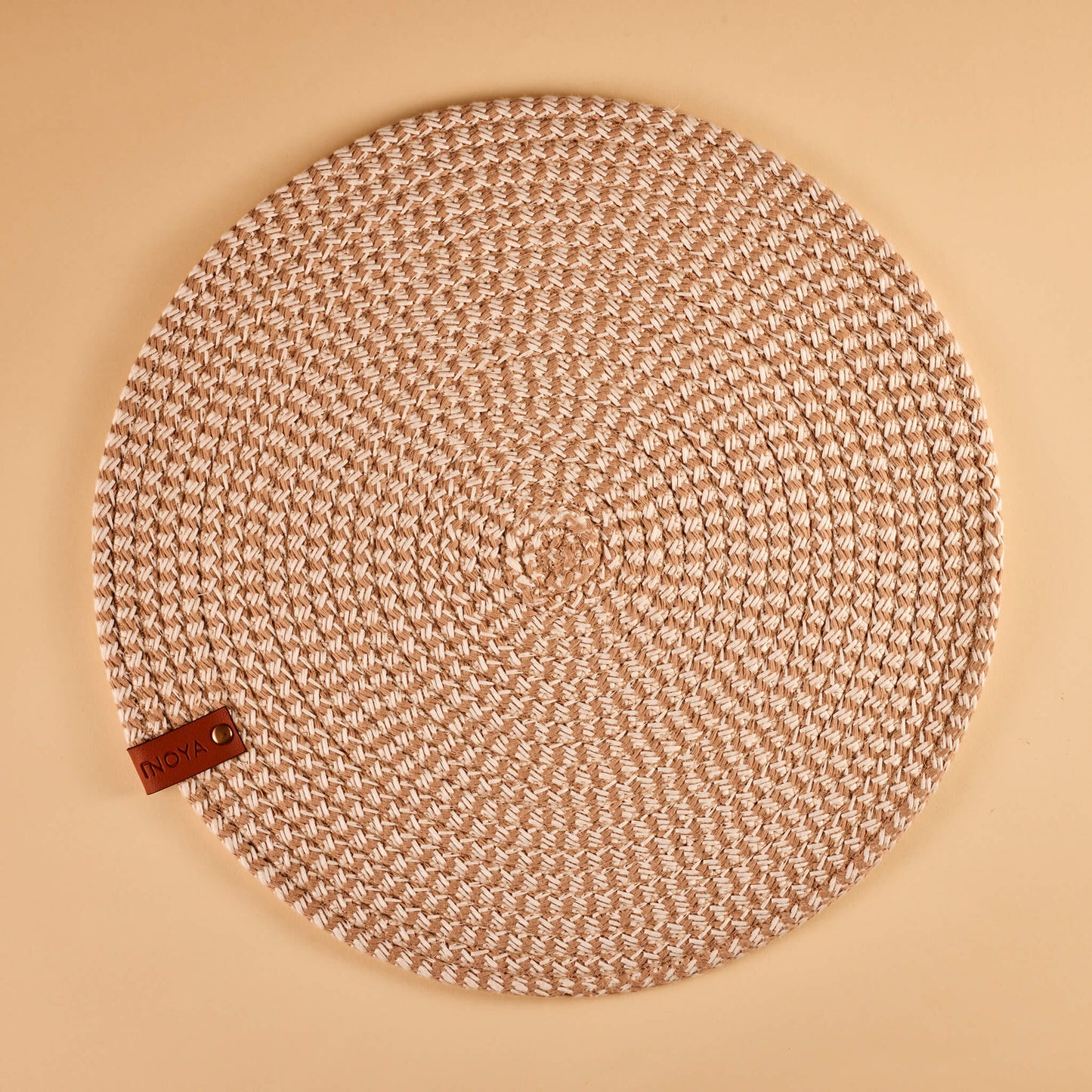 A round ash brown fabric placemat.
