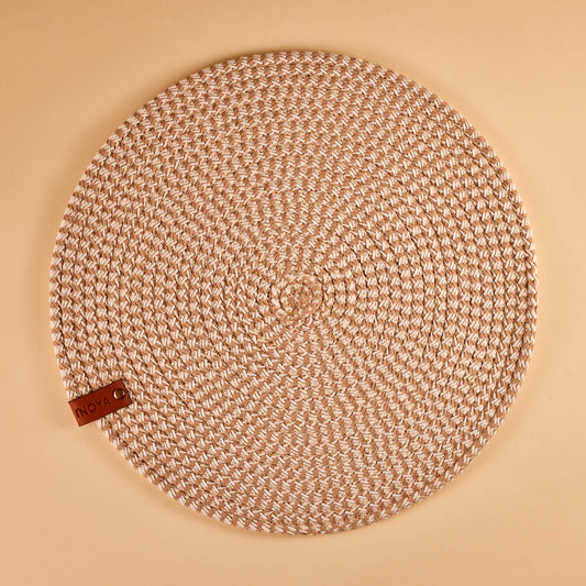 A round ash brown fabric placemat.