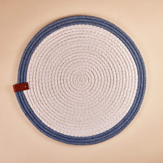 A round placemat with a white center and blue outer rim.