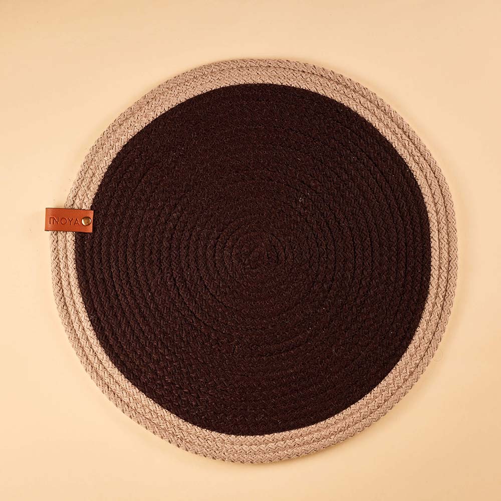 Round fabric placemat with a dark center and beige border.