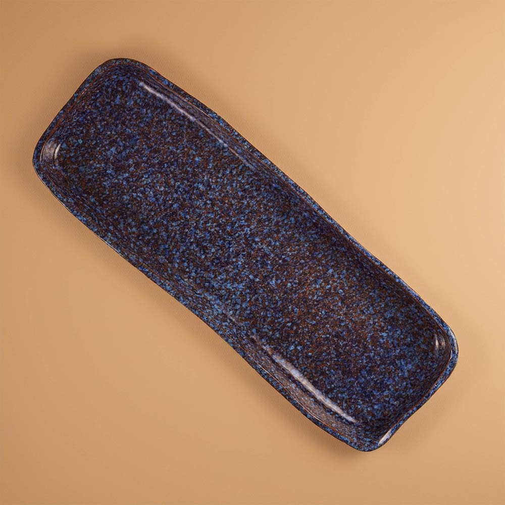 Blue stardust ceramic serving platter on a beige background