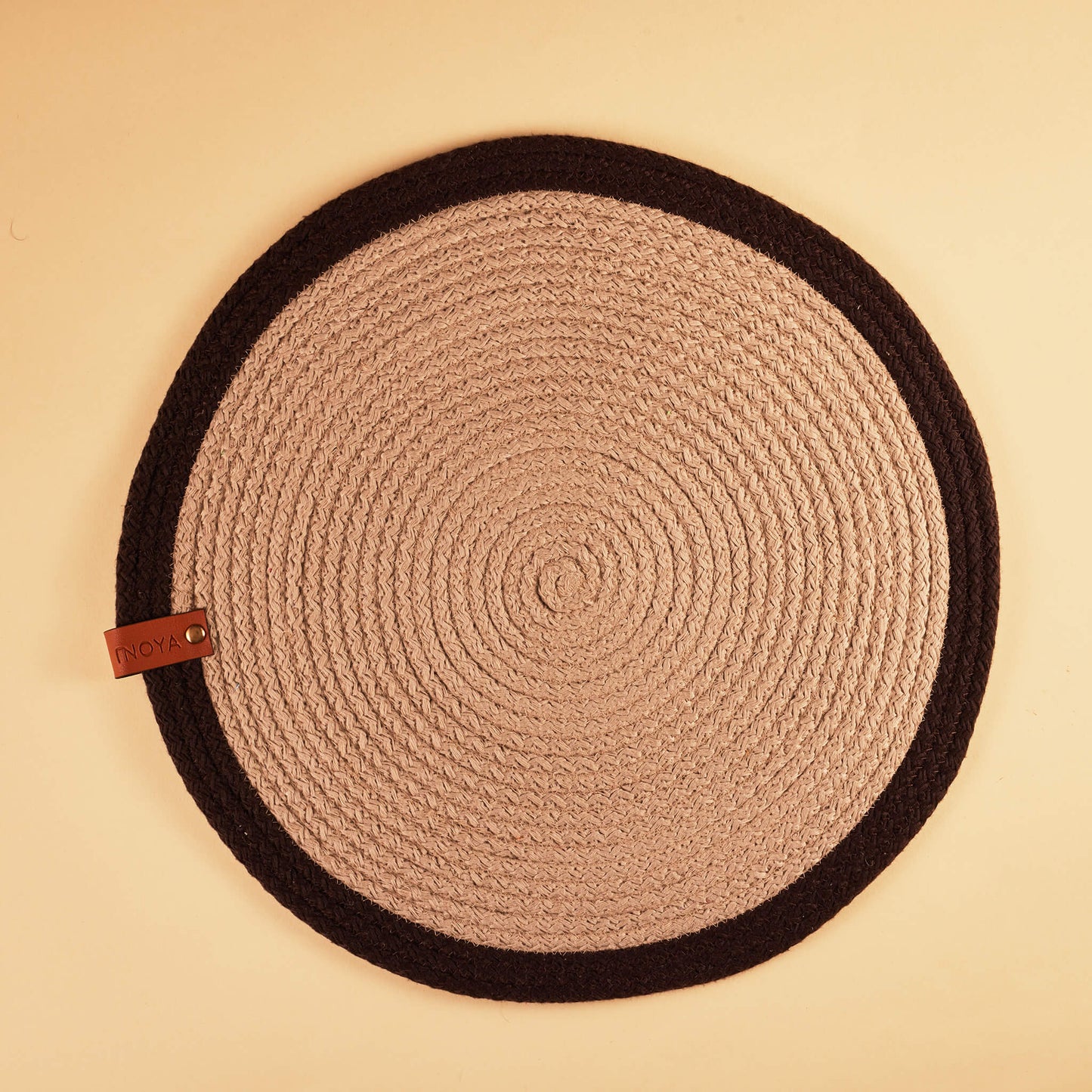 A round brown and beige placemat with darker brown border.