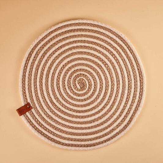 A beige and brown spiral fabric placemat.
