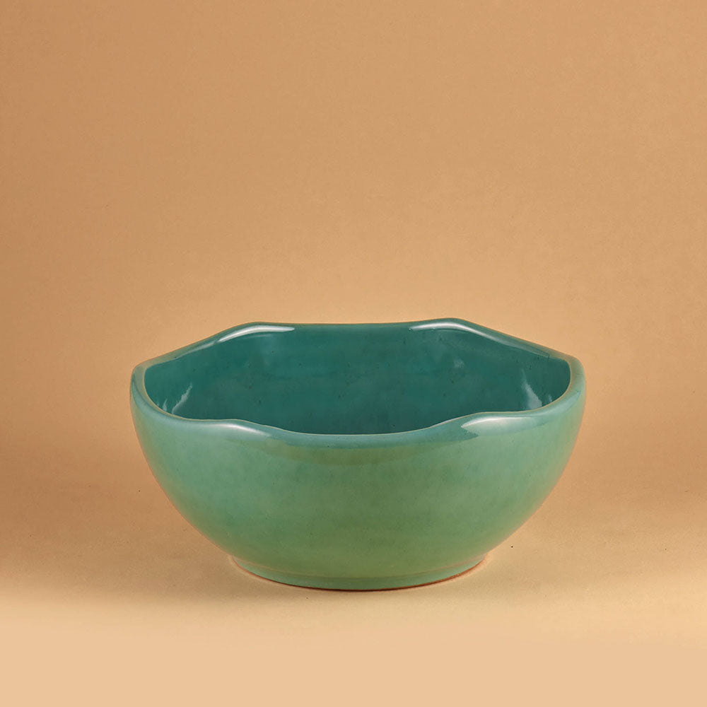 Jade ceramic bowl on a beige background