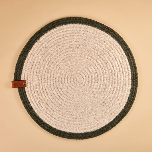 A round fabric placemat with a white center and olive border.