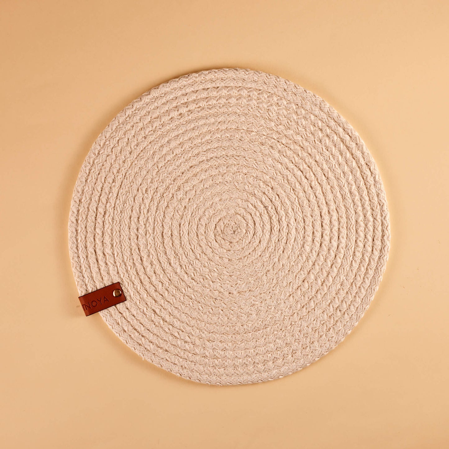 A white round fabric placemat.