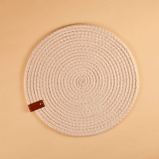 A white round fabric placemat.