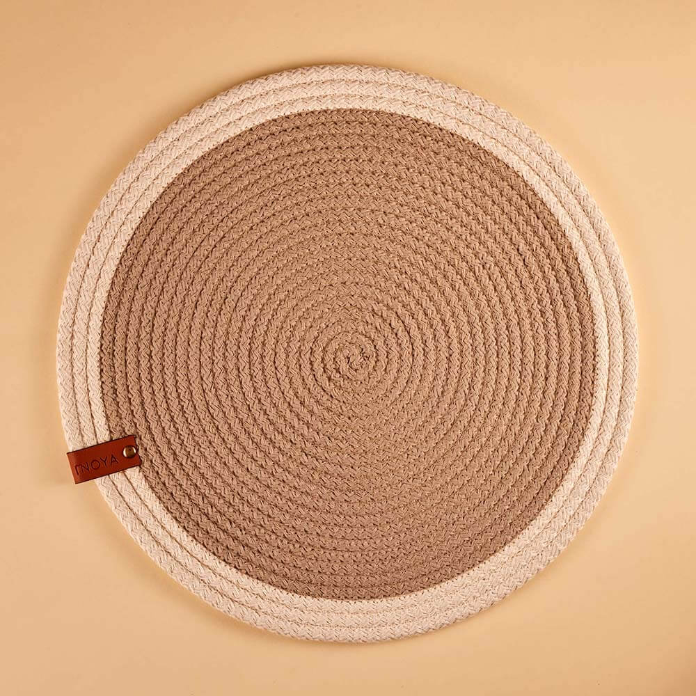 Round fabric placemat with a leather tag on a beige background