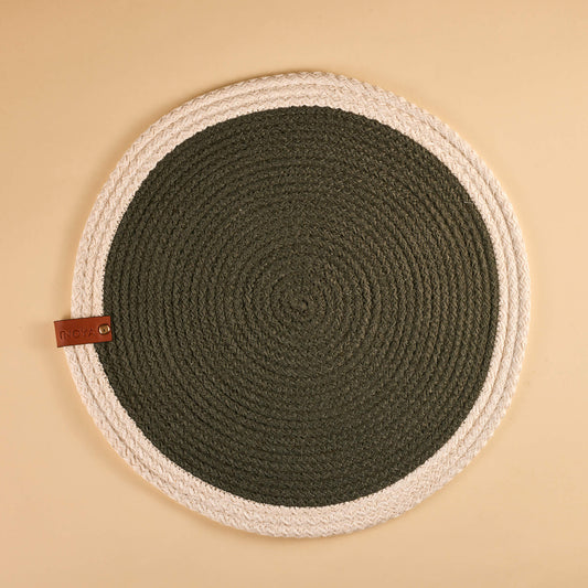 A round fabric placemat with a white border and a deep olive center.